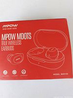 Front of red box showing MPOW MDots true wireless earbuds with charging case illustration and branding.