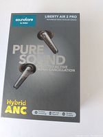 Front of retail box showing product name, branding, and key feature 'Pure Sound' with hybrid ANC technology