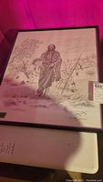 Framed monochrome sketch showing Native American man Quanah Comanche warlord, teepees in background, signed by Dan Brewer Buffler.