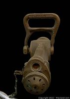 Front view showing large handle with '1 1/2 WATER FOG NOZZLE' embossed, nozzle tip with perforated front plate and chain attachment.