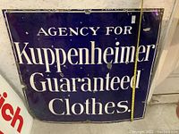 Front view of the rectangular enamel porcelain sign with blue background and white lettering, showing text and some edge wear.