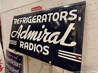 Front view of navy blue enamel sign with white lettering