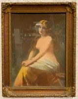 Front view of Art Deco semi-nude woman print showing the seated figure draped partially in cloth with decorative carved frame.