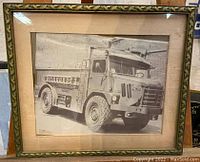 Frontal view of the framed vintage black and white photo of Logan Airport firetruck showing details of the truck and frame condition.