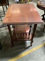 Front and side view of cherry wood stand showing rectangular top and turned spindle details.