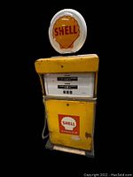 Full front view of entire gas pump showing body, hose, globe