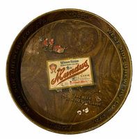 Front view of round metal beer tray with brown marbled appearance, central label for Mundus Beer, and illustrations of brownies and people.
