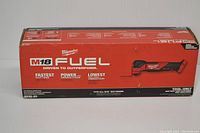 Photo of the front and side of the Milwaukee M18 FUEL multi-tool sealed retail box showing model and features.