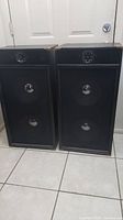 Two vintage custom guitar speaker cabinets side by side showing full height and front face