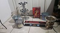 Overview of lot showing liquor dispenser, ice buckets, metal bucket, bar mat and cocktail tools box