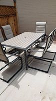 Full view of table and six chairs on patio