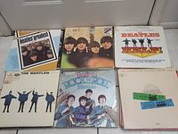 Six Beatles albums arranged in two rows: Beatles’ Greatest; Beatles ’65; Beatles HELP!; The Beatles (White Album); Beatlemania! The World’s Greatest Rockers; Live at the Hollywood Bowl