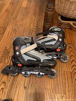 Side view of Schwinn inline rollerblades showing frame, wheels, and boot details with scratches and wear.