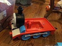 Thomas the Train red, blue, black, and white electric humidifier with face resembling Thomas engine.