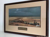 Framed artwork visible hanging on wall, showing a desolate train scene with wooden frame and glass.