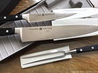 Overview of two knives and carving fork in original case.