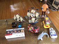 Wide view showing all items in lot arranged on wooden table