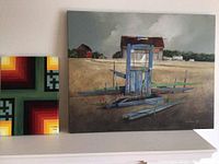 Two paintings side by side on shelf