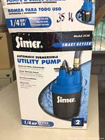 Box showing model and features of Simer automatic submersible utility pump.