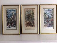 Three framed vintage 1960s watercolor paintings depicting Paris city scenes hung side-by-side.