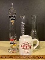 Full lot photo with mug, Galileo thermometer, KIMAX beaker, smoke-colored conical beaker