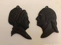 Both cast iron silhouettes of George and Martha Washington side by side displaying size and profile details.