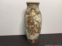 Front view showing samurai and helper panel on oviform Satsuma vase with gold and floral accents.