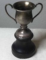 Sterling silver miniature trophy with black base