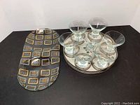Vintage barware including silver tray with matching coasters, seven glasses, and glass snack dish
