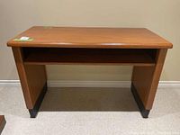 Wood console table front view showing smooth wooden surface, storage shelf and overall condition.