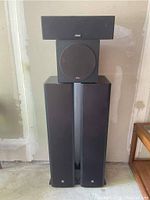 Front view of two Boston CS226 floor standing speakers with KLH Bassbite V subwoofer and Yamaha NS-AP100 centre speaker stacked on top.
