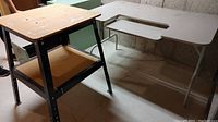 Photo showing the metal frame workbench with two wooden shelves next to the folding desk table