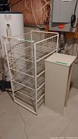 Photo showing white wire storage rack beside the laminate shoe storage shelf in basement setting