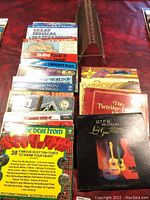 Photo of vinyl records arranged vertically, showing titles and cover art for various albums including Scottish tunes and themed collections.