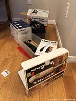 Overview photo showing boxes of Hamilton Beach hand mixer, Black and Decker Spacemaker can opener, Cuisinart electric knife, and Moulinex hand blender.