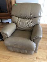 Front angle of tan leather recliner on hardwood floor