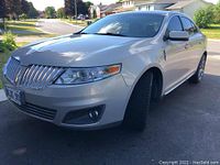 Front three-quarter view showing chrome grille, headlights and body panels