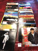 Overview image showing multiple vinyl records in sleeves arrayed on a table, featuring various artists including Corey Hart, Cat Stevens, Bruce Cockburn, Hall and Oates, and Santana.