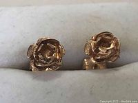 Front close-up view showing detailed flower shape and texture of earrings.