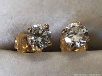 Front view of both earrings mounted in display box