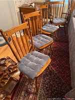 Set of six wooden side chairs and two arm chairs with blue tufted cushions