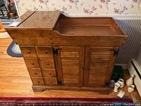 Full view of Ethan Allen dry sink showing copper tray liner on top right, folding countertop extension on left, four drawers on left side, two cabinet doors below.