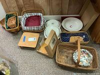 Photo showing full lot with baskets, pottery dishes, pasta bowl in box, and wooden board.