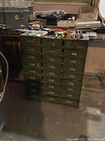 Full view of 27 drawer metal cabinet with tools on top but not included in sale, showing cabinet size and storage drawers.
