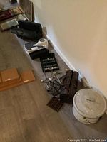 Overall lot showing vintage medical bags, enamel chamber pot, stethoscopes, case with weights, and accessories arranged on floor.