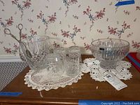 Overall lot on table showing bowl, ice bucket with tongs, four glasses and doilies