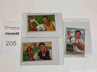 Three 1952 Bowman baseball cards in protective sleeves, showing front artwork of players Del Rice, Eddie Fitzgerald, and Solly Hemus
