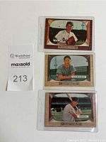 Full set of 3 vintage 1955 Bowman baseball cards displayed in plastic sleeves: Preacher Roe, Al "Red" Schoendienst, Mickie Vernon.