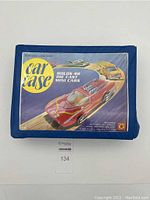 Blue plastic car case closed with vintage-style label showing car illustrations and claim 'Holds 48 die cast mini cars'