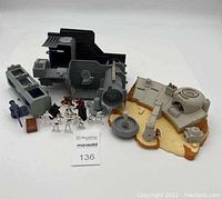 Photo showing both the Death Star World play set with components in grey and black, along with the Podrace Arena with tan base. Also shows many small plastic figurines posed in front.